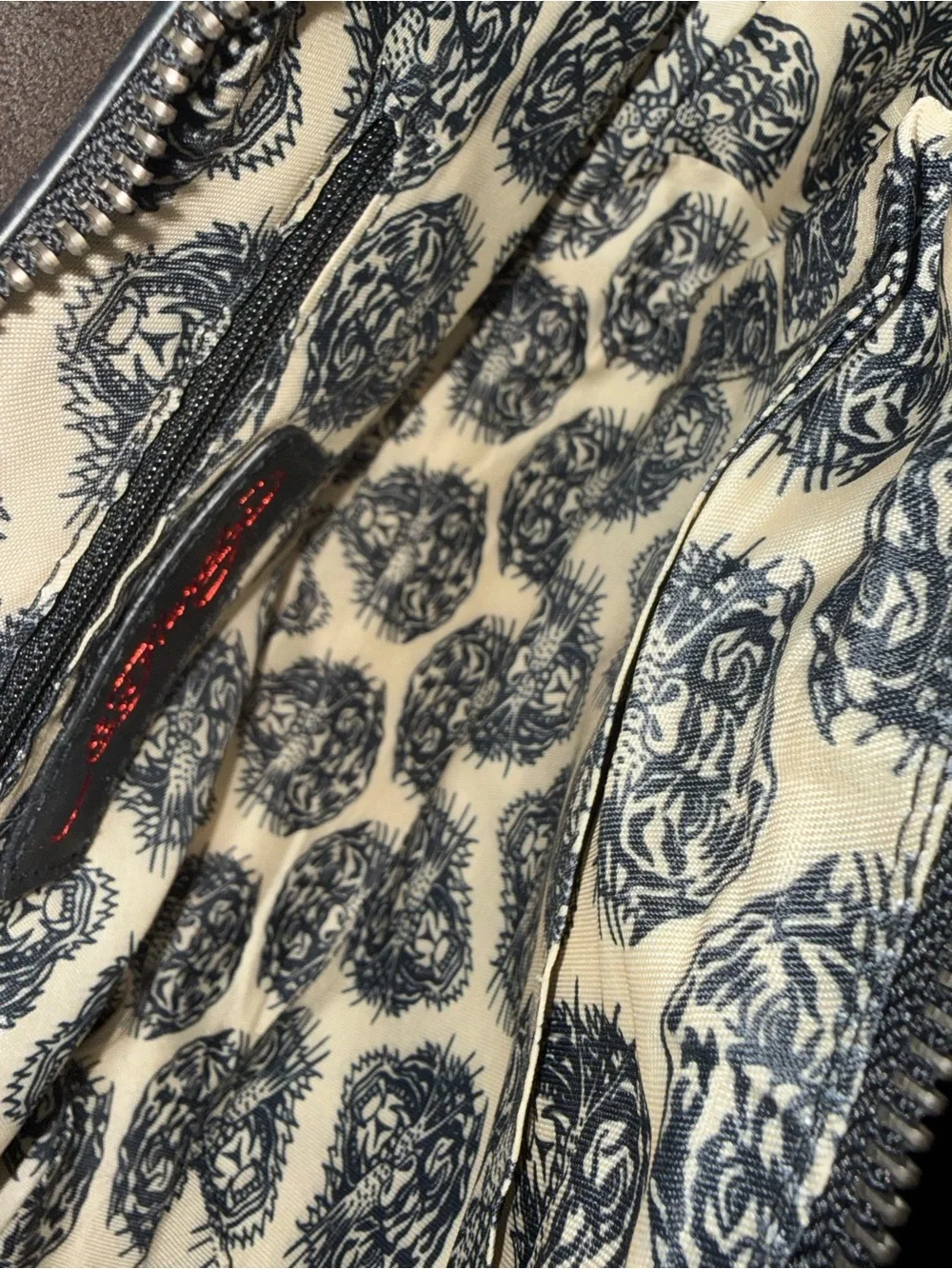 Signature Ed Hardy tattoo print Shoulder Bag with Skull, Rose & Pink accents.